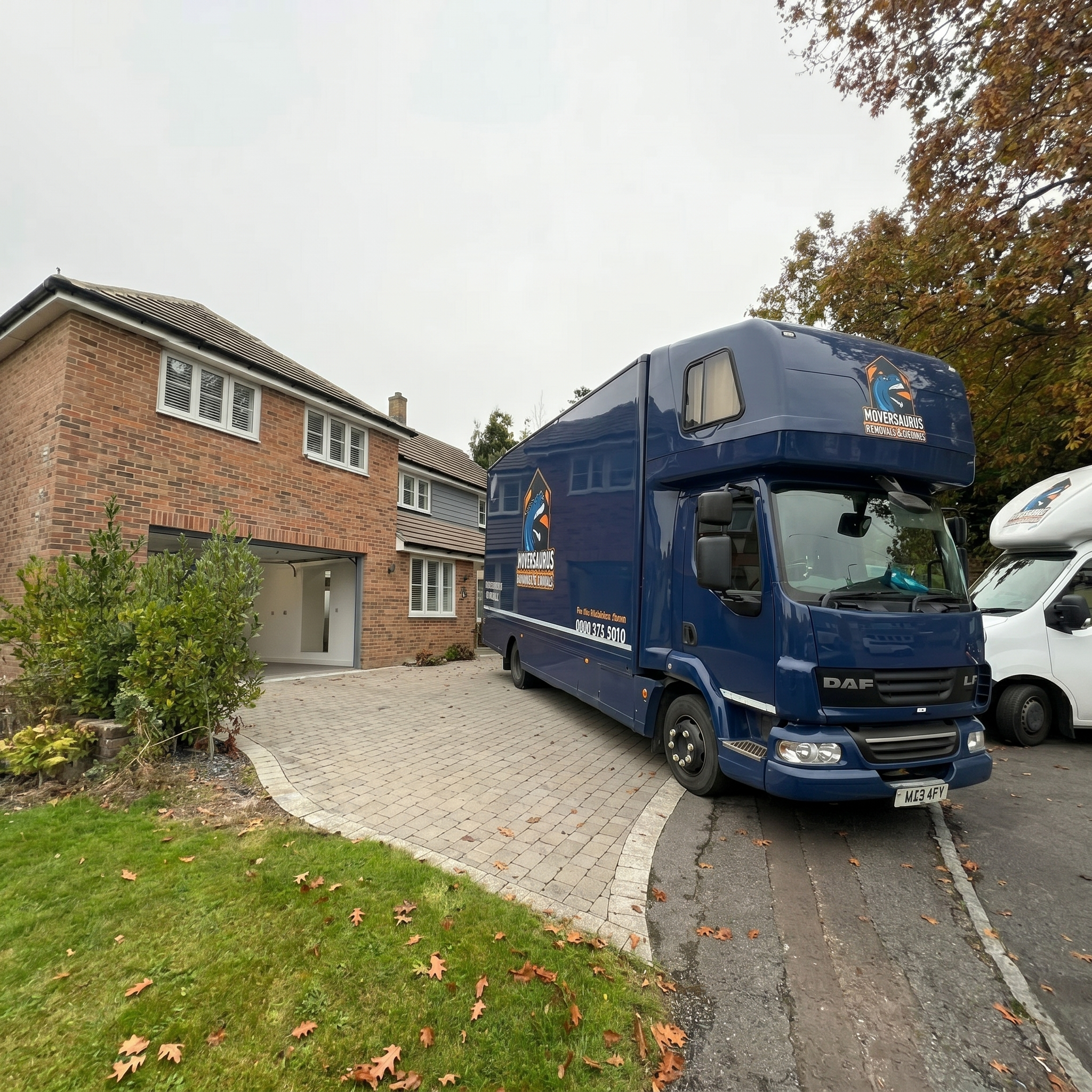 Moversaurus branded lorry parked on a residential driveway during a click and collect storage collection