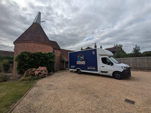 Moversaurus crew loading furniture from a West Sussex home into the branded navy luton lorry