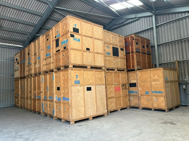 Inside the Moversaurus warehouse — stacked storage crates in a secure West Sussex facility